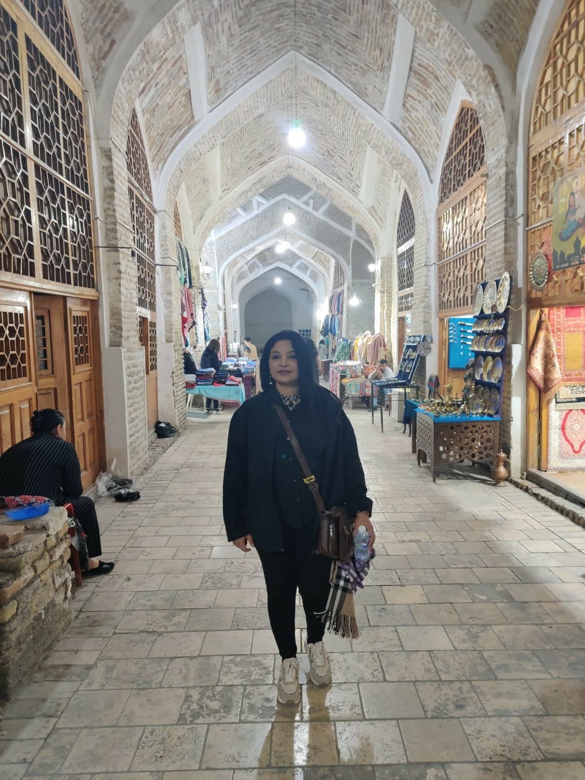 Explorer walking through the ancient old streets of Bukhara