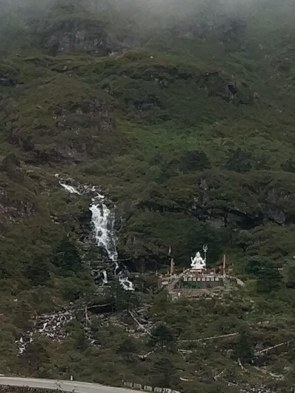 White Lord Shiva statue and cascading stream at New Baba Harbhajan Singh Mandir