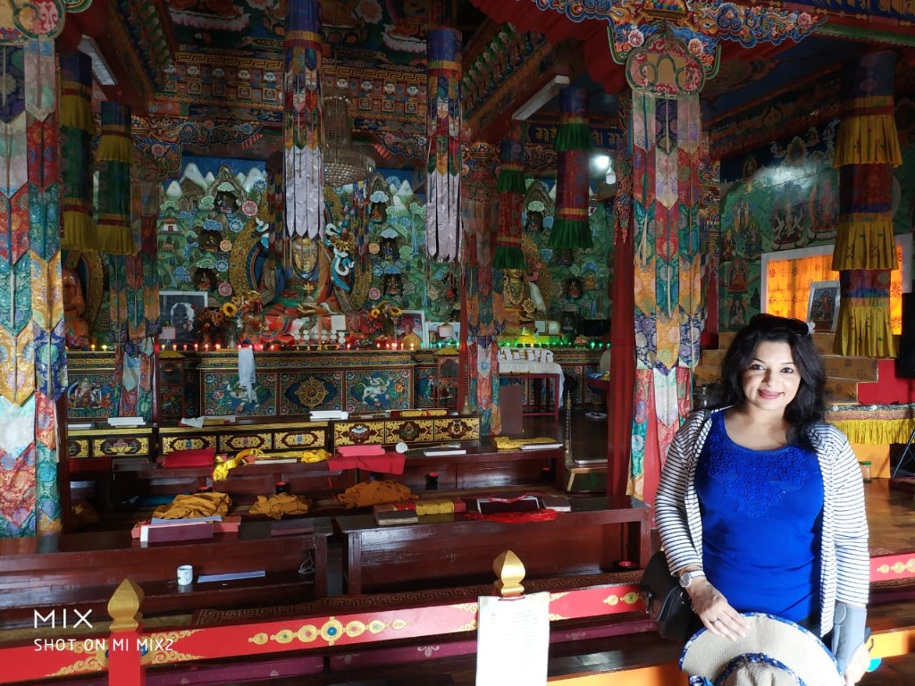 Interior prayer hall of Gonjang Monastery decorated with colorful silk thangkas and murals