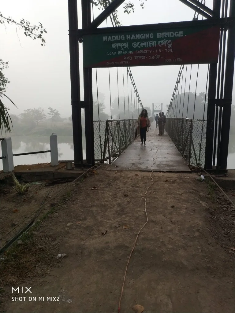 Crossing the Hadug Hanging Bridge at Pobitora