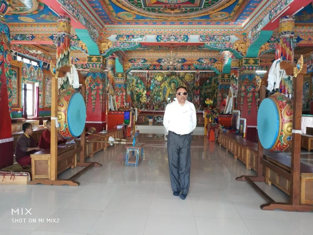 Intricate Tibetan murals and ceremonial drums inside Chillipam Monastery prayer hall