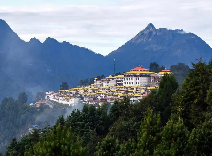 Majestic Tawang Monastery perching over green mountain valleys and misty Himalayan peaks in Arunachal Pradesh