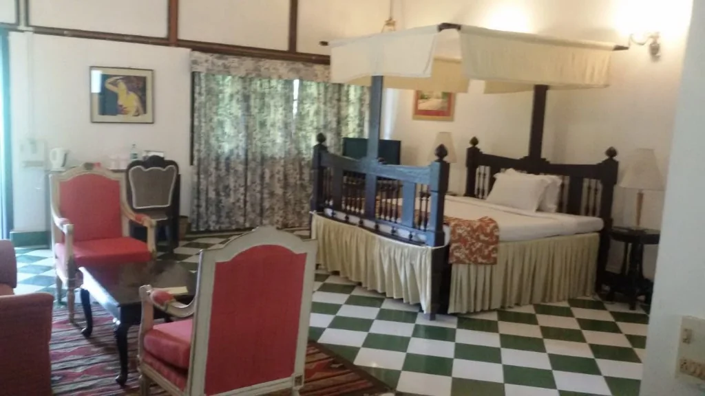 Bedroom with four-poster bed inside the heritage tea bungalow