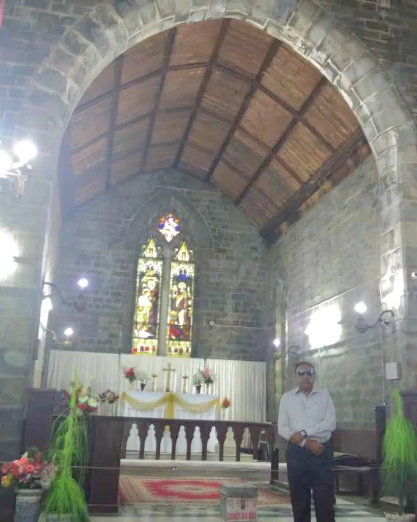 Interior of St. John in the Wilderness Church showing altar and stained glass windows