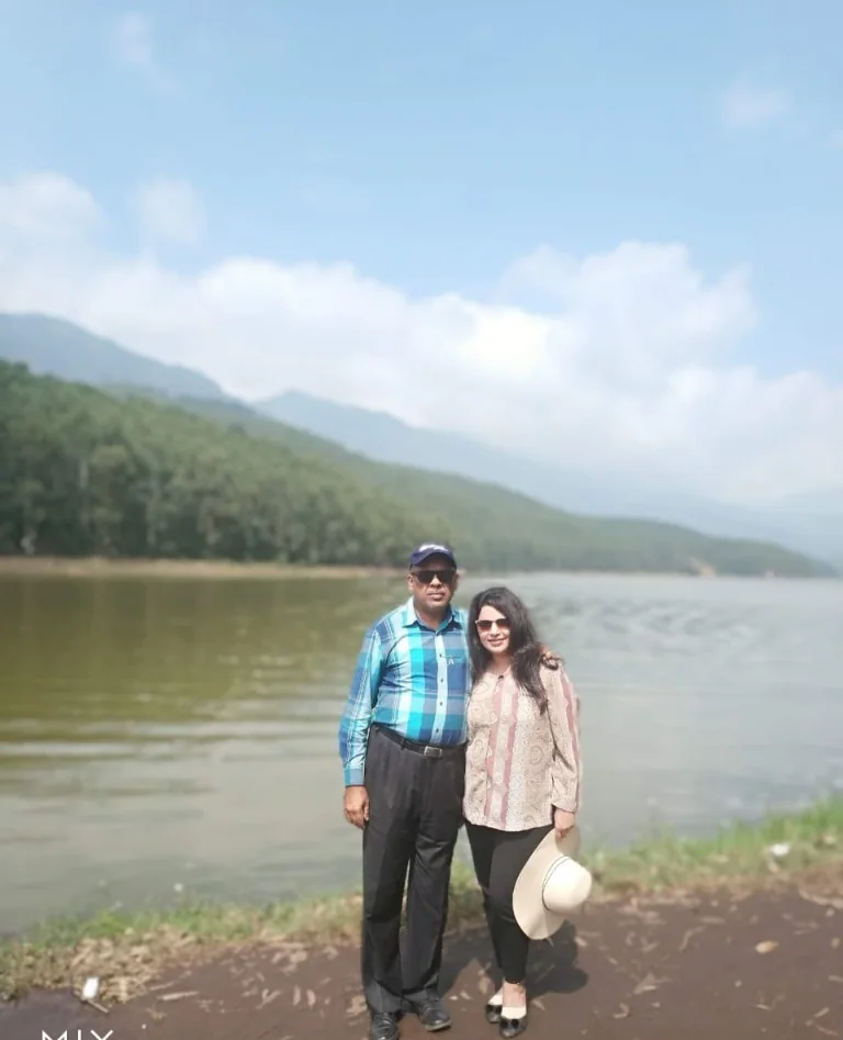 Misty views at Mattupetty Dam reservoir surrounded by green hills in Munnar