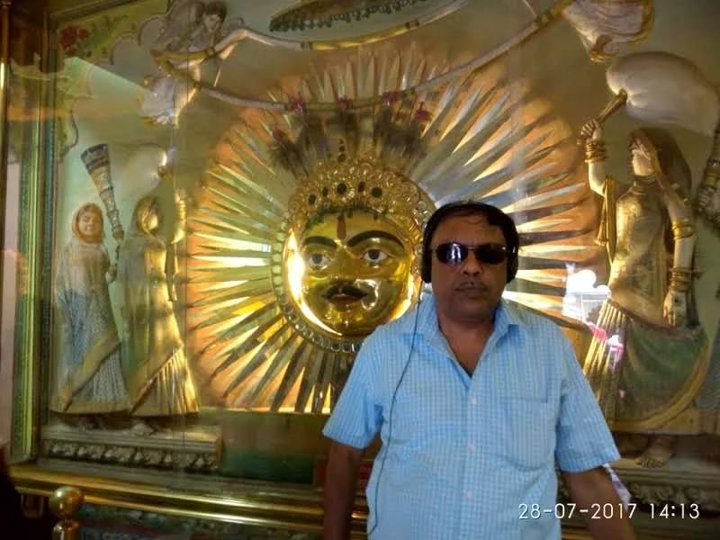 Golden Sun God Surya emblem with radiant golden rays and royal attendants at Surya Chopar in Udaipur City Palace